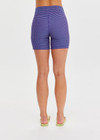 THE UPSIDE women's purple check Aliki 5inch Spin Short offers a firm, supportive fit with mid-rise in a recycled textured fabric. Made for yoga and pilates.