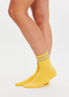 THE UPSIDE women’s yellow Curio Crew Sock with jaquard stripes in gold metallic yarn.