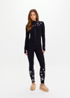 THE UPSIDE women’s black Superstar Nova Jumpsuit offers a firm & supportive fit in our jacquard stretch fabrication and features a mock neck zip through and thumb holes. Designed for Après-ski and winter wear.