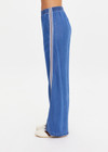THE UPSIDE women’s blue Lykke Juliet Pant in soft chambray features a low-rise fit, split hem, and contrasting mesh knit side stripe. The perfect travel pant.