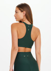 THE UPSIDE women’s green Maneki Jetta Racerback Bra features a V-neck in recycled fabric, removable cups, and elastic underbust support. Made for yoga and pilates.