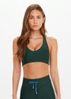 THE UPSIDE women’s green Maneki Jetta Racerback Bra features a V-neck in recycled fabric, removable cups, and elastic underbust support. Made for yoga and pilates.
