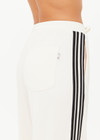 THE UPSIDE women’s cream Roma Pant is a true-to-size fit and features an elasticated waistband with drawcord, pockets and black and cream contrast stripes down sides. Perfect for everyday.