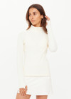THE UPSIDE women's cream Courtship Dova Run Top is a form fitting long-sleeve and features a quarter zip opening with mock neck, thumb holes and invisible zip pockets. Made for running.