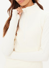 THE UPSIDE women's cream Courtship Dova Run Top is a form fitting long-sleeve and features a quarter zip opening with mock neck, thumb holes and invisible zip pockets. Made for running.