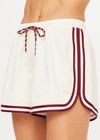 THE UPSIDE women's cream Klio Short is designed for a mid-rise, relaxed fit and features a soft elasticated waistband with drawcord and contrast binds in maroon along curved hem. Made for everyday.