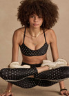 THE UPSIDE women's black Moonstone Zoe Bra offers a soft, supportive fit with a scooped low neckline, T-bar back, and adjustable elastic straps. Made for yoga & pilates.