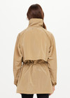 THE UPSIDE women's brown Rylan Anorak is relaxed fit, mid-length, made from tan wrinkled water-resistant fabric. Made for yoga & pilates.