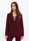 THE UPSIDE women's maroon Mendoza Boyfriend Blazer is designed as a boyfriend style single breasted blazer with cream piping along side seams, tortoiseshell buttons and front welt pockets.