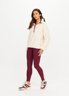 THE UPSIDE women's natural recycled polyester Harlow Fleece Pullover has a relaxed fit with a striped rib collar, contrast maroon stripes, and zip pockets. Made for lifestyle