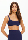 THE UPSIDE women's navy recycled peached Maison Rory Scoop Bra features a scooped square neckline and removable cups. Made for yoga & pilates.