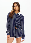 THE UPSIDE women's navy & white stripe Belize Bobbi Collared Shirt features a ruffled detail and sleeve cuff with button closure in linen fabrication. Made for lifestyle.