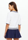 THE UPSIDE women's white tennis, pickleball & padel Archie Collared Knit Polo is made from organic cotton and features navy & dusty blue striped ribbing at front placket, collar and hem.