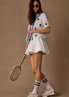 THE UPSIDE women's white tennis, pickleball & padel Daria Skort is made from organic cotton and features an internal short with elasticated waistband and drawcord.