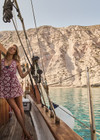THE UPSIDE women's floral organic cotton Lahaina Maxine Wrap Mini Dress features a V neckline, wide straps and wooden bead ends on drawcord. Made for lifestyle.