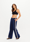 THE UPSIDE women's navy Galaxia Loretta Pant is designed for a mid to low rise fit and features elasticated waistband, drawcord with side seam pockets and knitted tape down sides. Made for lifestyle.