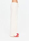 THE UPSIDE women's cream cotton Noosa Calling Track Pant is a low-rise straight leg pant with a soft elastic waistband, made from soft brushed recycled fabric. Made for lifestyle.