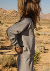 THE UPSIDE women's grey cotton Hit The Road Track Top is a relaxed raglan crew neck sweater in french terry fabrication with a ribbed neckline, arms and cuffs. Made for lifestyle.