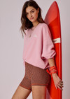 THE UPSIDE women's pink organic cotton Paloma Crew Neck Sweater offers a boxy fit and features a drop shoulder and The Upside logo printed on front chest. Made for everyday wear.