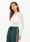 THE UPSIDE women's cream Lyon Rosa Long Sleeve Top is a fitted, sheer lace style with a crew neckline. Made for everyday wear and layering.