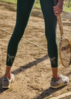 THE UPSIDE women's green recycled soft peached Racquet 25inch Pocket Legging is mid-rise and features side pockets, an elasticated drawcord and mini scallop lce detailing at cuffs. Made for tennis, golf & pickleball.