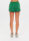 THE UPSIDE women's green recycled Austen Run Short made from quick drying performance fabric features a curved hem with cotton lace scalloped edge detailing, navy in-built shorts and invisible zip pockets. Made for running, tennis, golf & pickleball.