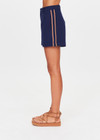 THE UPSIDE women's navy Toledo Leon Bermuda Short is a longerline tailored short featuring tan knitted tape down sides, flat waistband with belt loops and side pockets. Made for lifestyle.