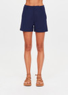 THE UPSIDE women's navy Toledo Leon Bermuda Short is a longerline tailored short featuring tan knitted tape down sides, flat waistband with belt loops and side pockets. Made for lifestyle.
