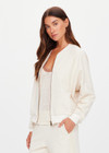 THE UPSIDE women's cream Navar Isabella Bomber Jacket is an oversized fit with raglan sleeves in our castilla "TU" design and features a front patch pocket, crafted from a knitted jacquard fabrication. Made for everyday wear.