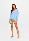 THE UPSIDE women's blue organic cotton Rever Josette V Neck Sweater is designed for a relaxed fit and features a striped V neckline in yellow and blue and contrast starts on sleeves. Made for everyday.