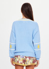 THE UPSIDE women's blue organic cotton Rever Josette V Neck Sweater is designed for a relaxed fit and features a striped V neckline in yellow and blue and contrast starts on sleeves. Made for everyday.