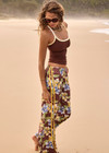 THE UPSIDE women's floral Isla Juliet Pant offers a relaxed fit in our vintage Isla hibiscus design and features an elasticated waistband with pockets, a split hem detail and yellow contrast binds. Made for lifestyle.