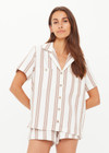 THE UPSIDE women's mocha stripe organic cotton Baja Katia Collared Shirt offers a relaxed fit and features a collar, patch pockets and wooden coconut buttons. Made for lifestyle.