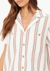 THE UPSIDE women's mocha stripe organic cotton Baja Katia Collared Shirt offers a relaxed fit and features a collar, patch pockets and wooden coconut buttons. Made for lifestyle.