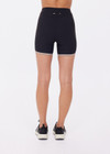 THE UPSIDE women's black recycled rib Rhythm 5inch Spin Short is mid-rise and features cream and mocha binds along side seams. Made for yoga & pilates.
