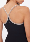 THE UPSIDE women's black recycled rib Rhythm Caleb Tank Top features a shelf bra with removable cups and cream and mocha binds along neckline. Made for yoga & pilates.