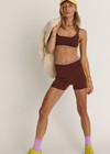 THE UPSIDE women's brown Montage Speechless Short offers a mid-rise fit with a soft waistband and features yellow side pannels, embroidered and rib detail. Made for yoga & pilates.
