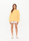 THE UPSIDE women's yellow organic cotton Paradise Coolum Crew is designed for an oversized fit, with discreet side seem pockets and ribbed neckline, cuffs and hem. Made for everyday wear.