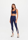 THE UPSIDE women's navy eco tech Toscan 25inch High Legging features a high-rise, breathable design with contrast mocha and cream binds along side seam. Made for yoga & pilates.