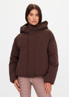 THE UPSIDE women's brown Mercer Hooded Puffer Jacket is fully lined and features invisible zip pockets with fleece lining, soft elasticated cuffs, a hood and is made from recycled fabric. Made for lifestyle.