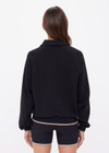 THE UPSIDE women's black organic cotton Collared Elle Polo is a relaxed fit long sleeve with a mocha stripe along ribbed hem and cuffs. Made for everyday wear.