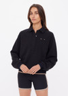 THE UPSIDE women's black organic cotton Collared Elle Polo is a relaxed fit long sleeve with a mocha stripe along ribbed hem and cuffs. Made for everyday wear.