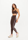 THE UPSIDE women's brown eco tech Oxford 25Inch Legging offers a mid rise with lilac coloured binds down side seams and an elastic drawcord through waist. Made for high impact.