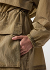 THE UPSIDE women's brown Rylan Anorak is designed for a relaxed fit, mid-length, made from tan wrinkled water-resistant fabric. Made for lifestyle.