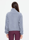 THE UPSIDE women’s grey recycled Sol Fleece Jacket has a relaxed fit with elastic waist and arm cuffs with polar fleece fabrication in marle. Made for lifestyle.