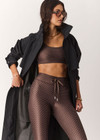 THE UPSIDE women's geo recycled supersoft Poet 25inch Midi Legging features a soft and supportive fit, mid rise waist, adjustable drawcord and signature geo print. Made for yoga and pilates.