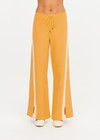 THE UPSIDE women's yellow organic cotton Bonito Moby Knit Pant is designed for a soft and supportive fit and features a high rise waist, side stripe detailing and adjustable drawcord. Made for lifestyle.