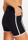 THE UPSIDE women's black Sol 3.5inch Spin Short offers a soft and supportive fit with a mid rise waist, side stripe detailing, pockets and adjustable drawcord. Made for yoga and pilates.