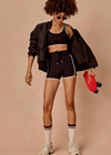THE UPSIDE women's black Sol 3.5inch Spin Short offers a soft and supportive fit with a mid rise waist, side stripe detailing, pockets and adjustable drawcord. Made for yoga and pilates.