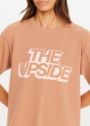 THE UPSIDE women’s brown 100% organic cotton Jacob Tee is designed for an oversized fit and features a ribbed collar and printed logo detail. Made for lifestyle.